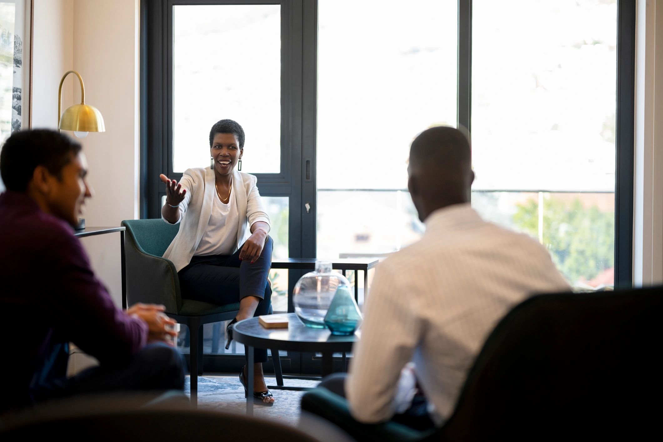 African businesswoman engages with employees in a collaborative meeting room